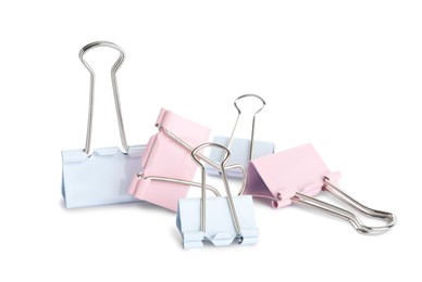 Photo of Colorful binder clips on white background. Stationery item