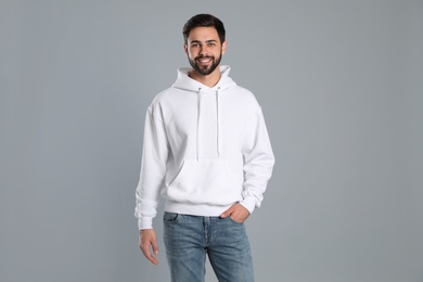 Portrait of young man in sweater on grey background. Mock up for design