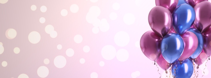 Image of Bright balloons on color background with bokeh effect, space for text. Banner design