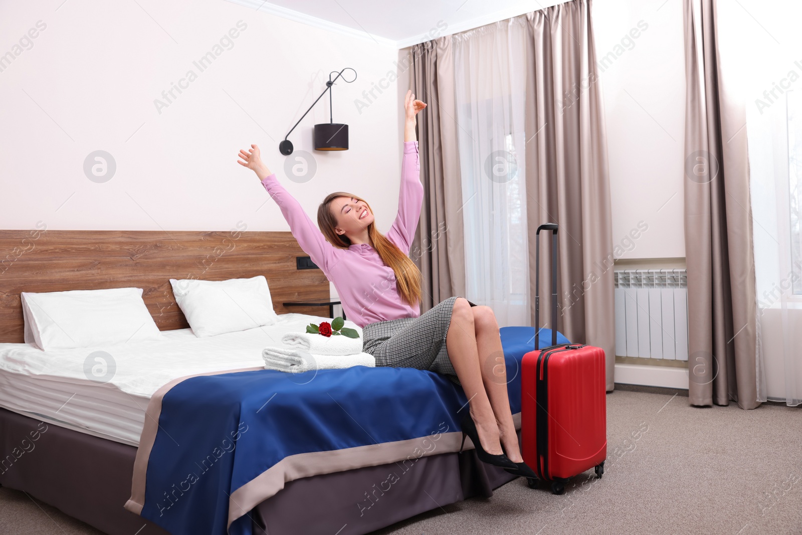 Photo of Beautiful businesswoman relaxing on bed in hotel room