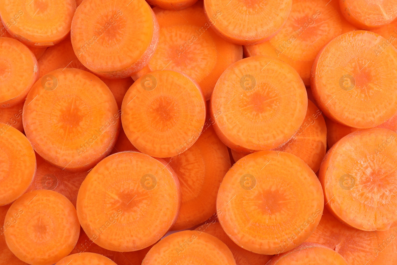 Slices of fresh ripe carrot as background, top view Photo of Slices of fresh ripe carrot as background, top view