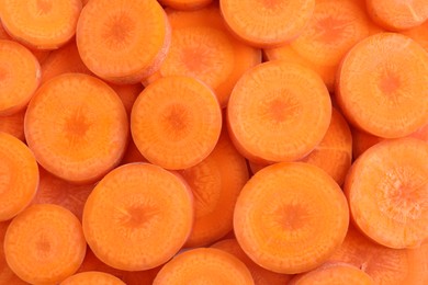 Photo of Slices of fresh ripe carrot as background, top view