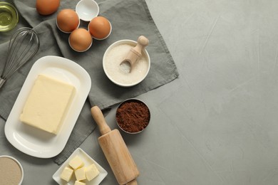 Photo of Flat lay composition with fresh butter and other products on grey table. Space for text