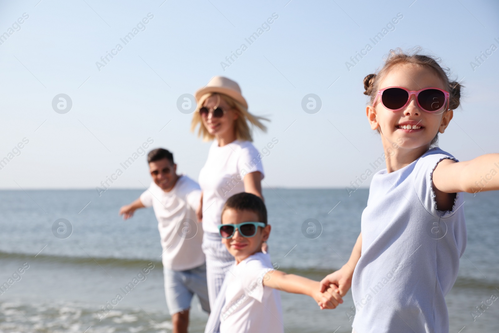 Photo of Happy family at beach on sunny summer day