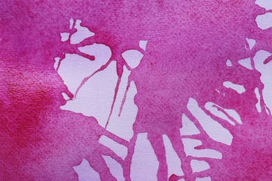 Abstract pink watercolor painting on white paper, top view