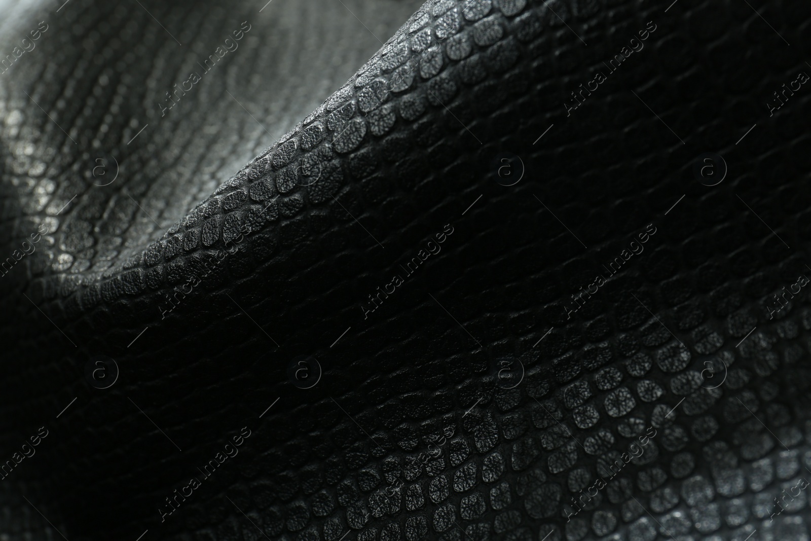 Photo of Black natural leather as background, closeup view