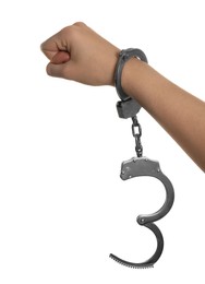 Photo of Freedom concept. Woman with handcuffs on her hand against white background, closeup
