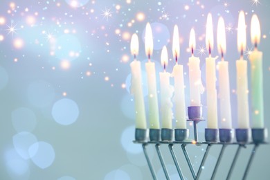 Image of Hanukkah celebration. Menorah with burning candles against blurred lights, closeup. Space for text