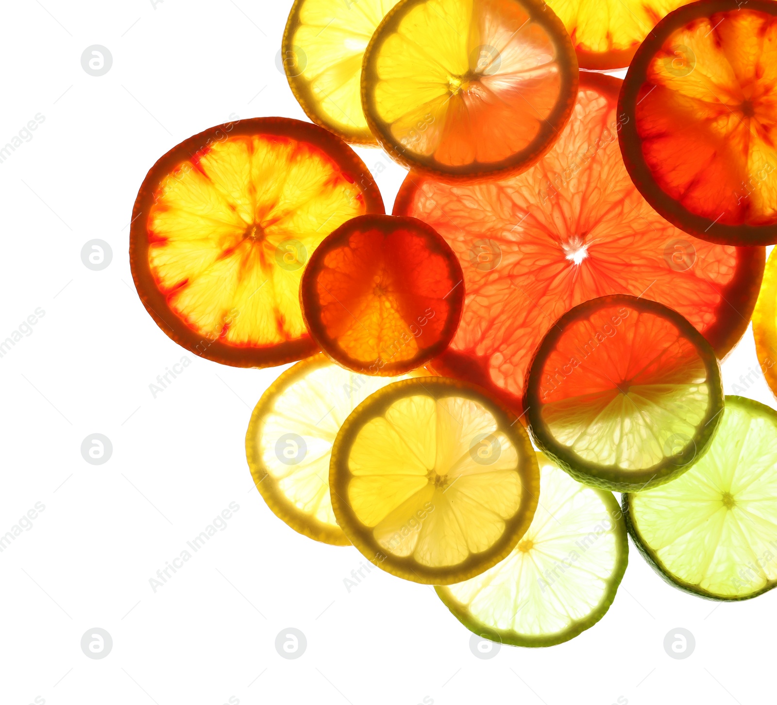 Photo of Illuminated slices of citrus fruits on white background, top view