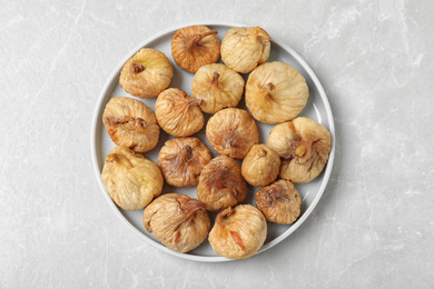 Photo of Tasty dried figs on light grey marble table, top view