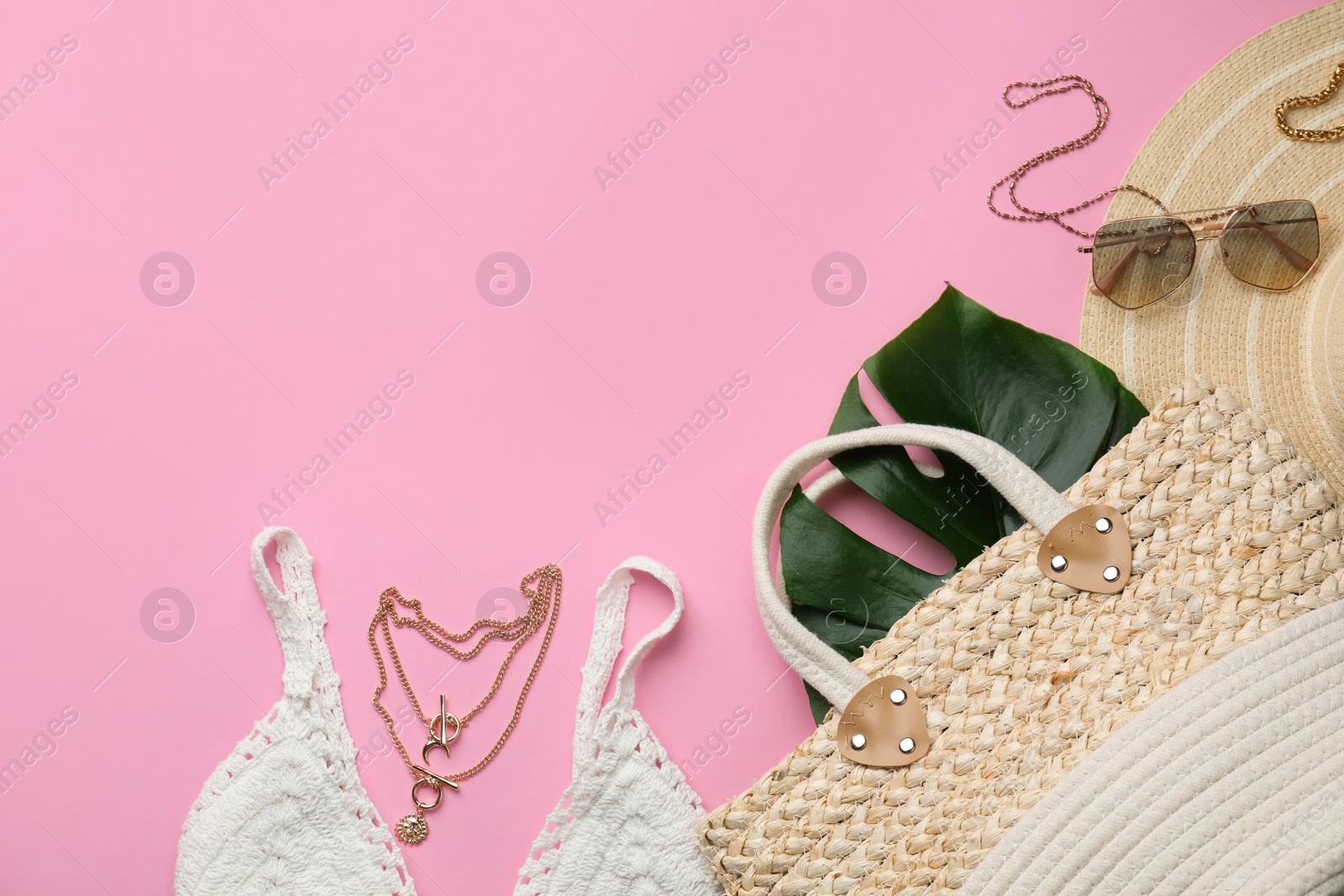 Photo of Flat lay composition with woman's straw bag on pink background. Space for text