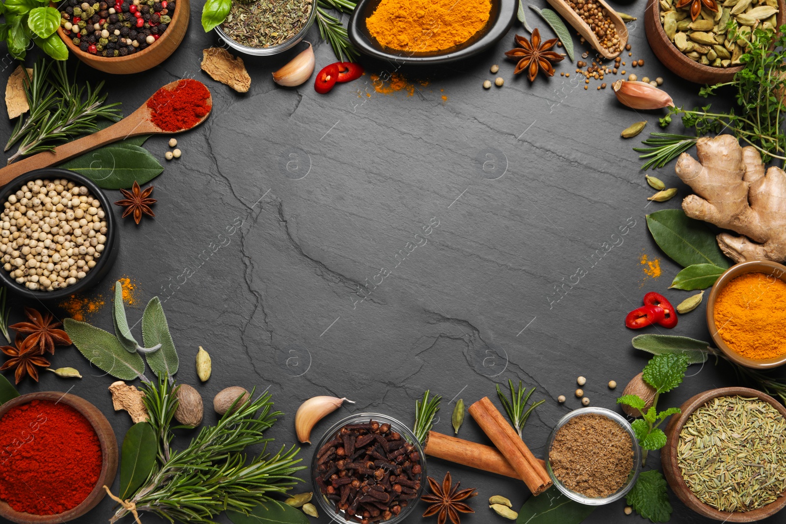 Photo of Frame of different herbs and spices on black table, flat lay. Space for text