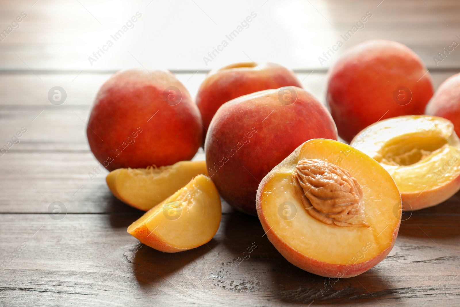 Photo of Fresh sweet peaches on wooden table, closeup