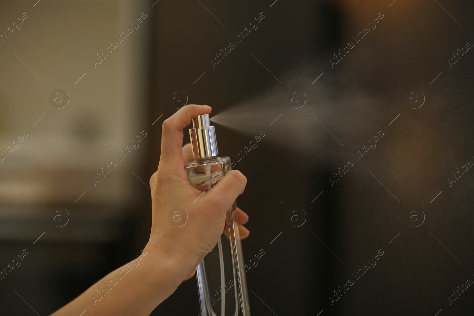 Photo of Woman spraying air freshener at home, closeup. Space for text