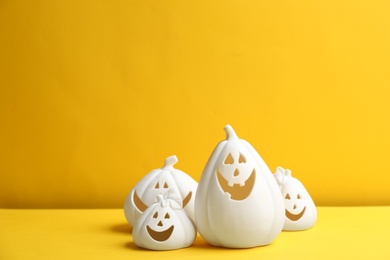 Jack-o-Lantern candle holders on yellow background. Halloween decor