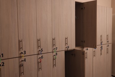 Photo of Many wooden lockers with keys and numbers on doors