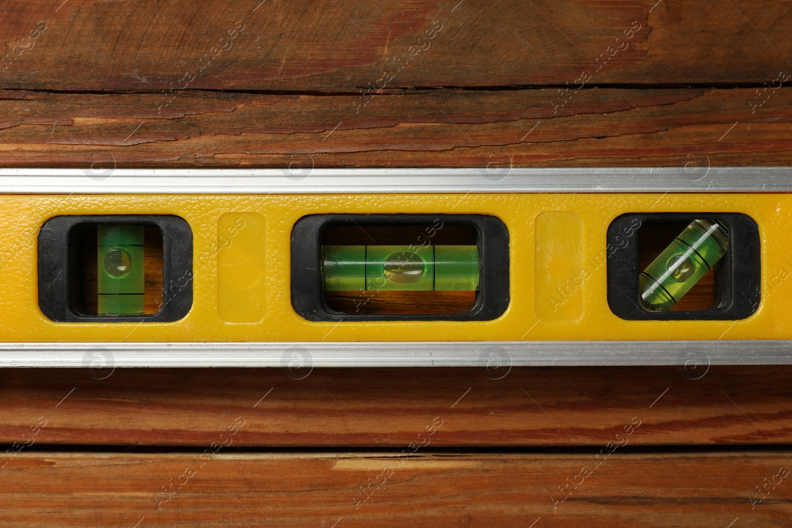 Photo of Building level on wooden table, top view