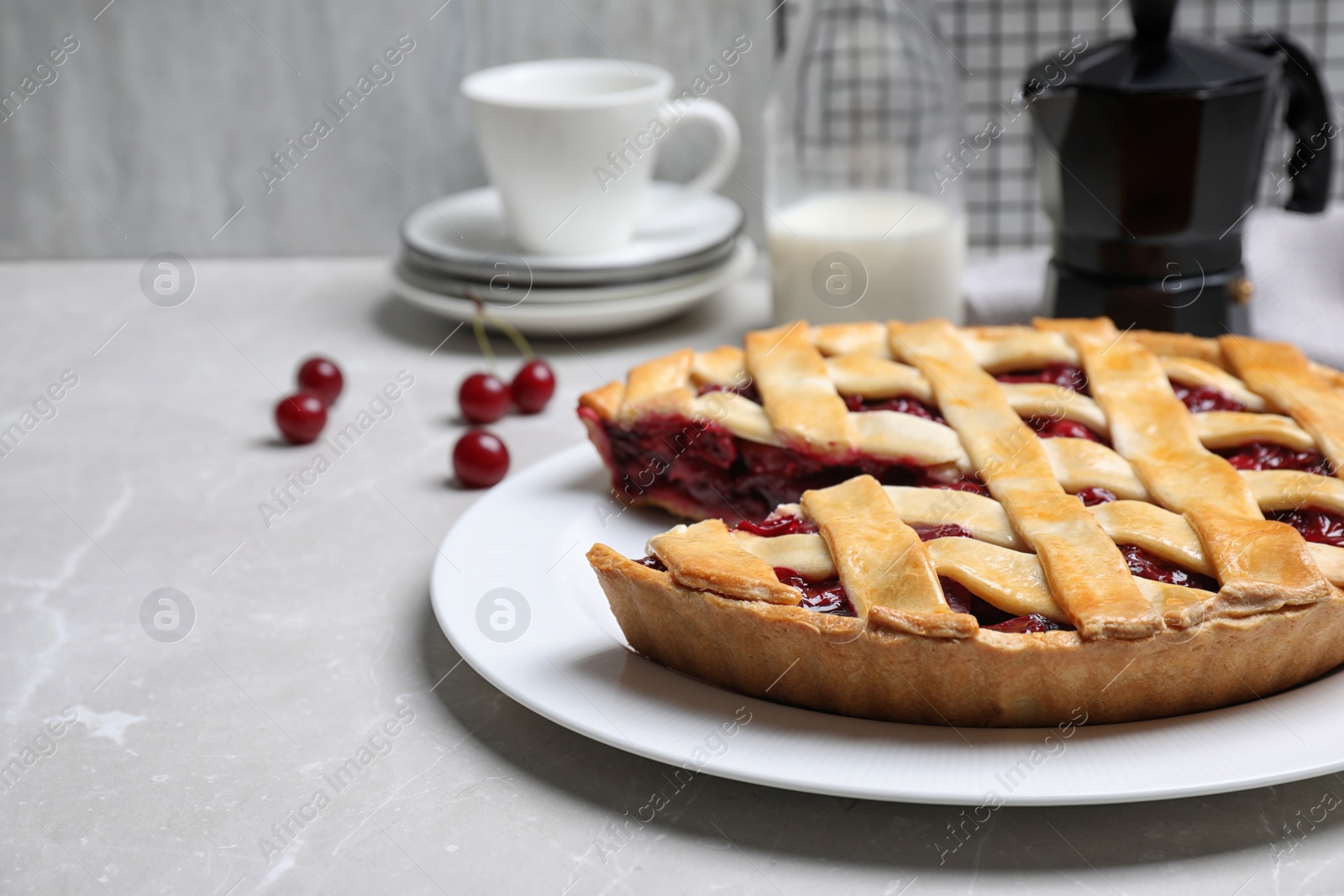 Photo of Delicious fresh cherry pie on light grey marble table