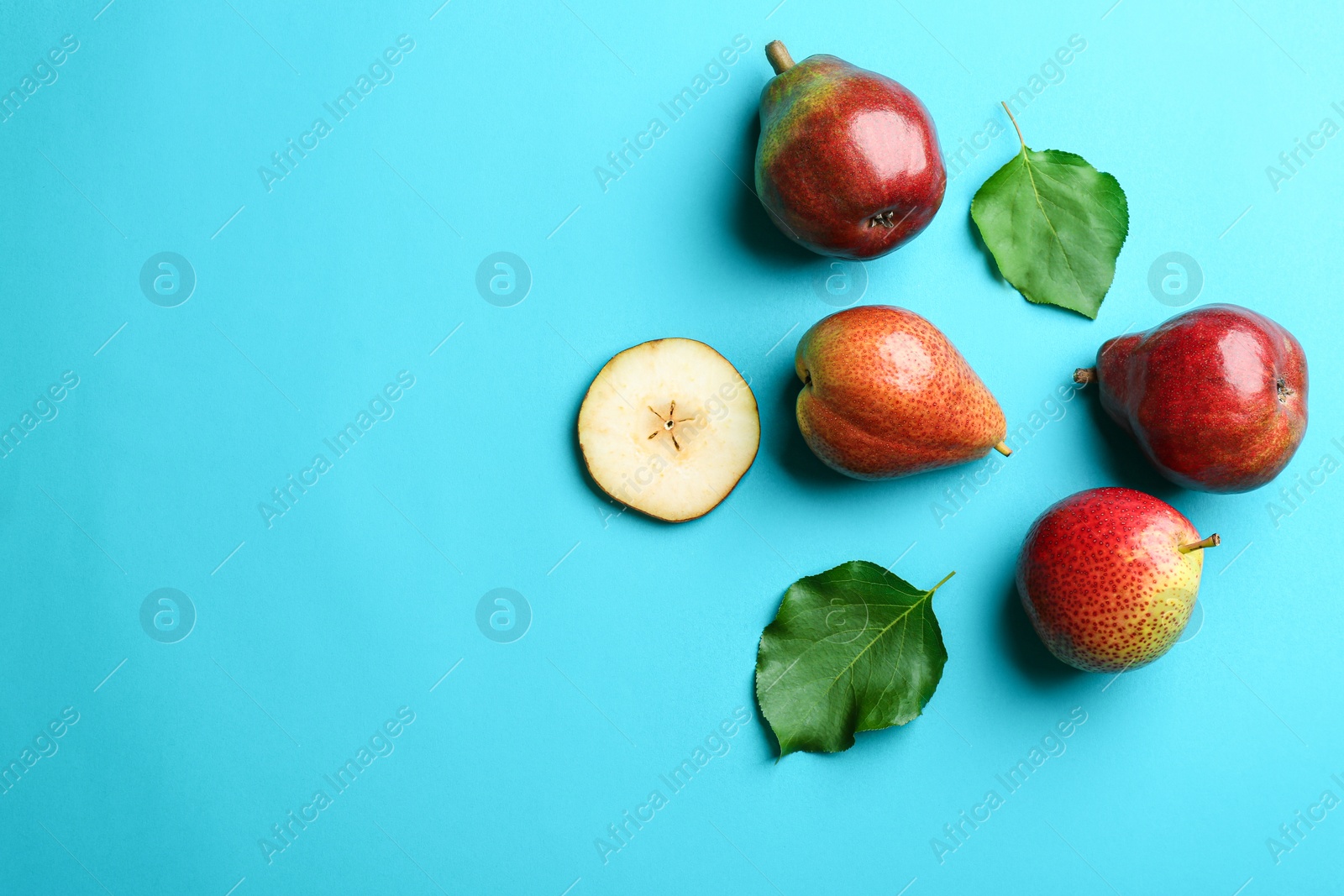 Photo of Ripe juicy pears on blue background, flat lay. Space for text