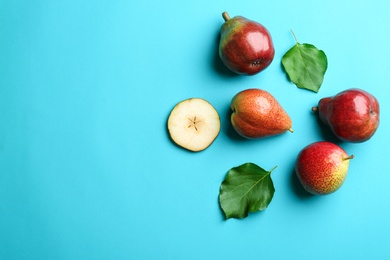 Ripe juicy pears on blue background, flat lay. Space for text