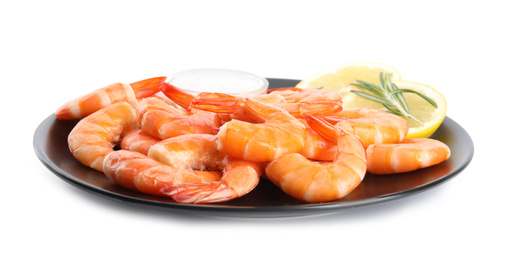 Photo of Delicious cooked shrimps served with lemon, salt and rosemary on white background