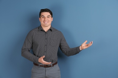 Photo of Portrait of young man in stylish outfit on color background