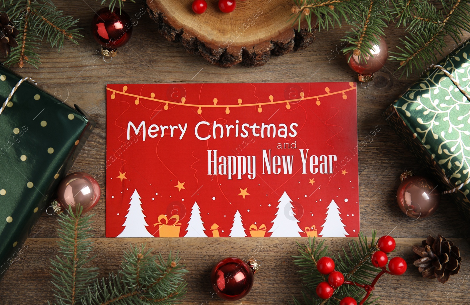 Photo of Flat lay composition with greeting card and Christmas decor on wooden background