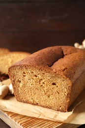 Photo of Delicious gingerbread cake on wooden board, closeup