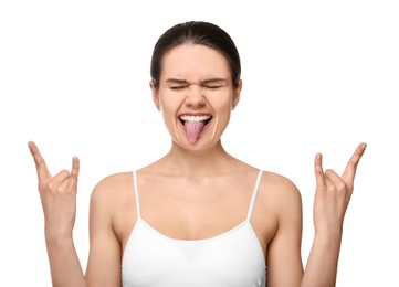 Photo of Happy young woman showing her tongue and rock gesture on white background