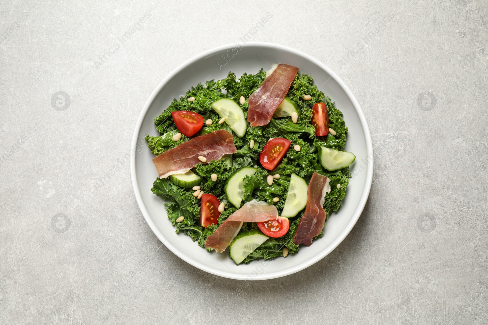 Photo of Delicious kale salad on grey table, top view