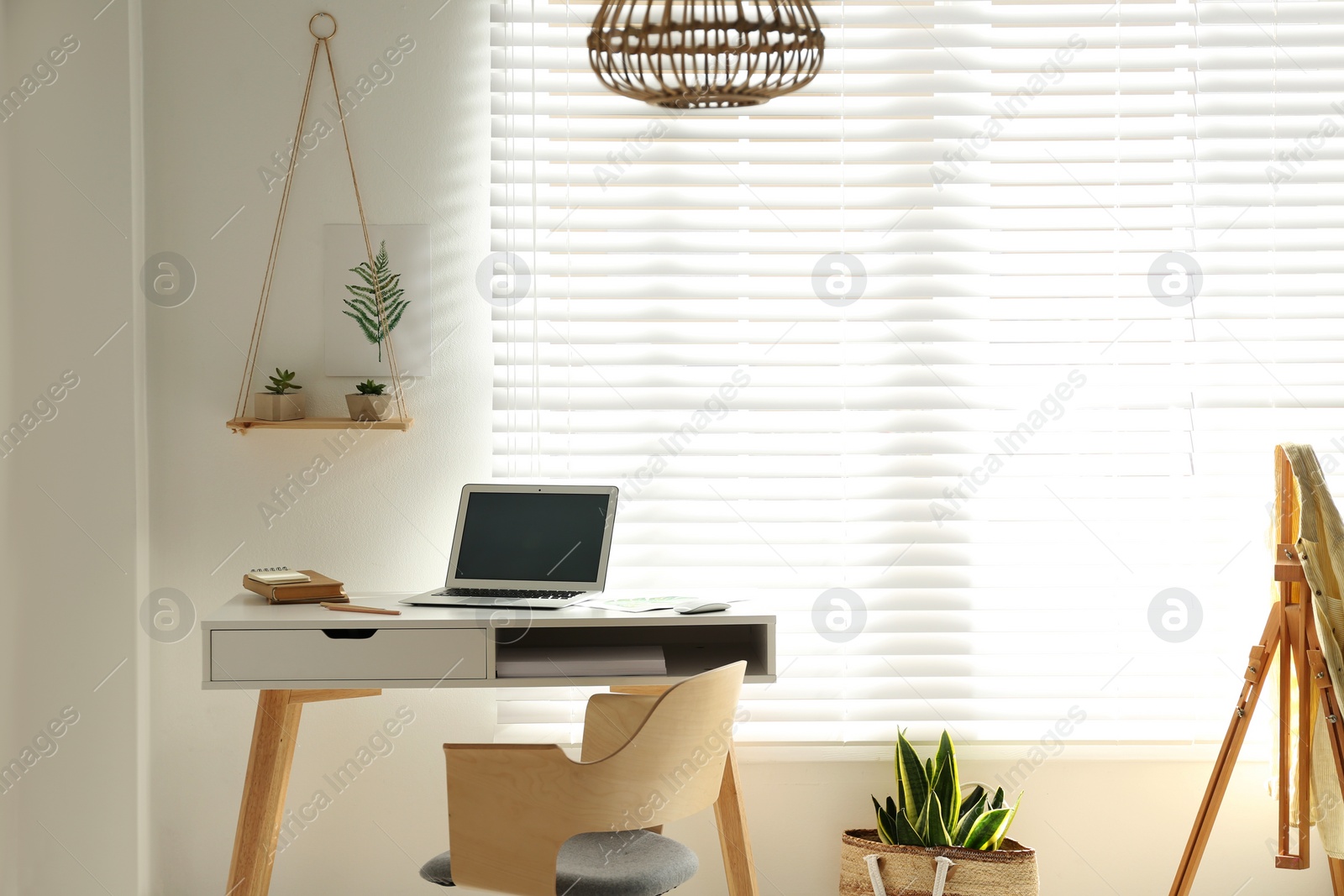 Photo of Stylish room interior with workplace near window