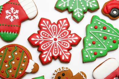 Photo of Different tasty Christmas cookies on white background, flat lay