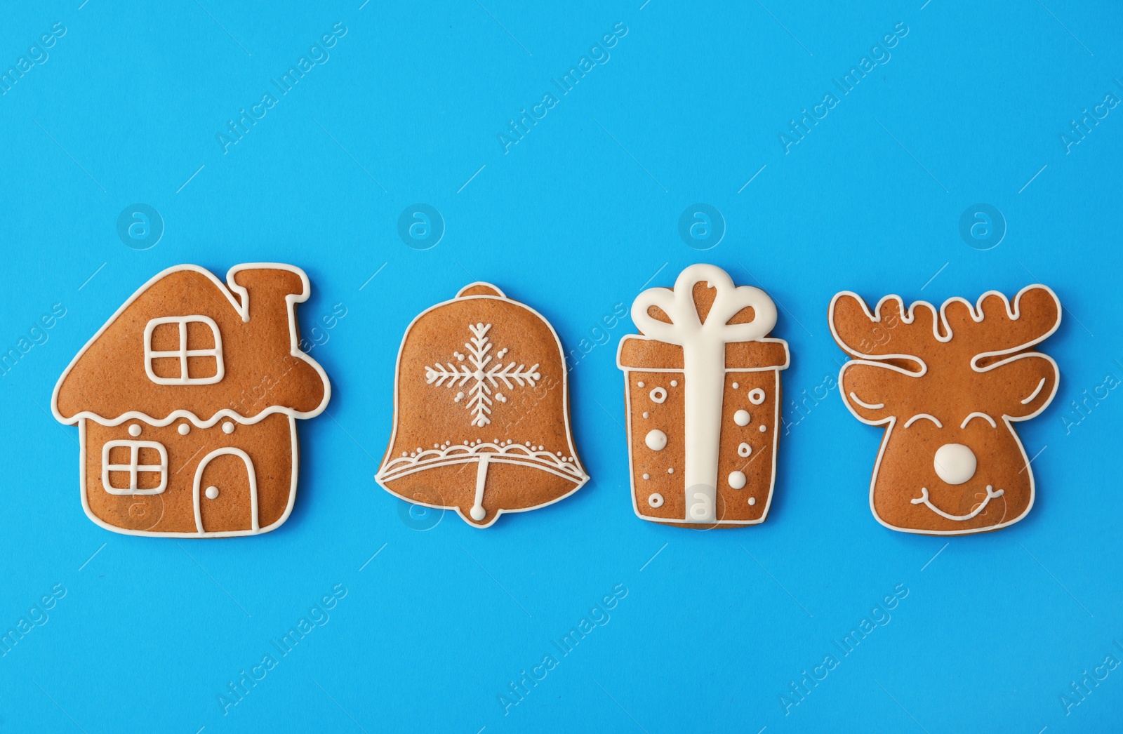 Photo of Different Christmas gingerbread cookies on light blue background, flat lay