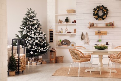 Photo of Cozy dining room interior with Christmas tree and festive decor