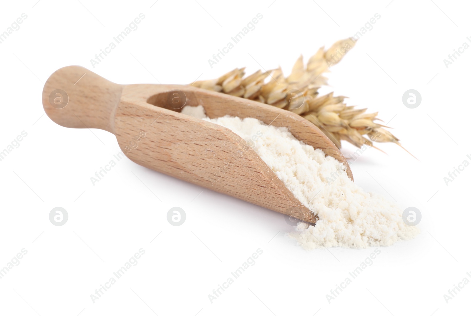 Photo of Wooden scoop with wheat flour and spikes isolated on white