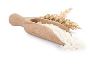 Wooden scoop with wheat flour and spikes isolated on white