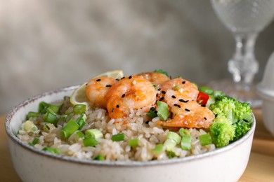 Photo of Tasty rice with shrimps and vegetables in bowl, closeup