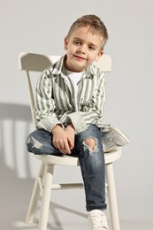 Photo of Fashion concept. Stylish boy on light grey background