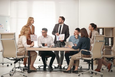 Photo of Businesspeople having meeting in office. Management consulting