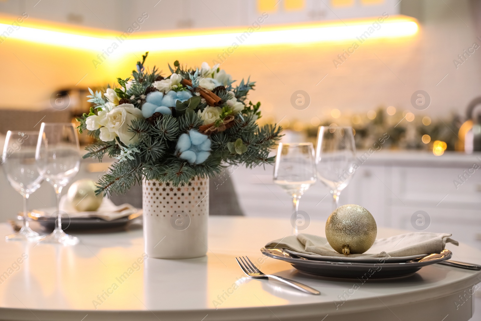 Photo of Beautiful winter bouquet on white table in kitchen