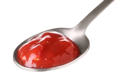 Metal spoon with red sauce on white background