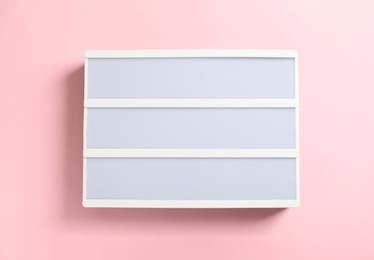 Photo of Blank letter board on pink background, top view