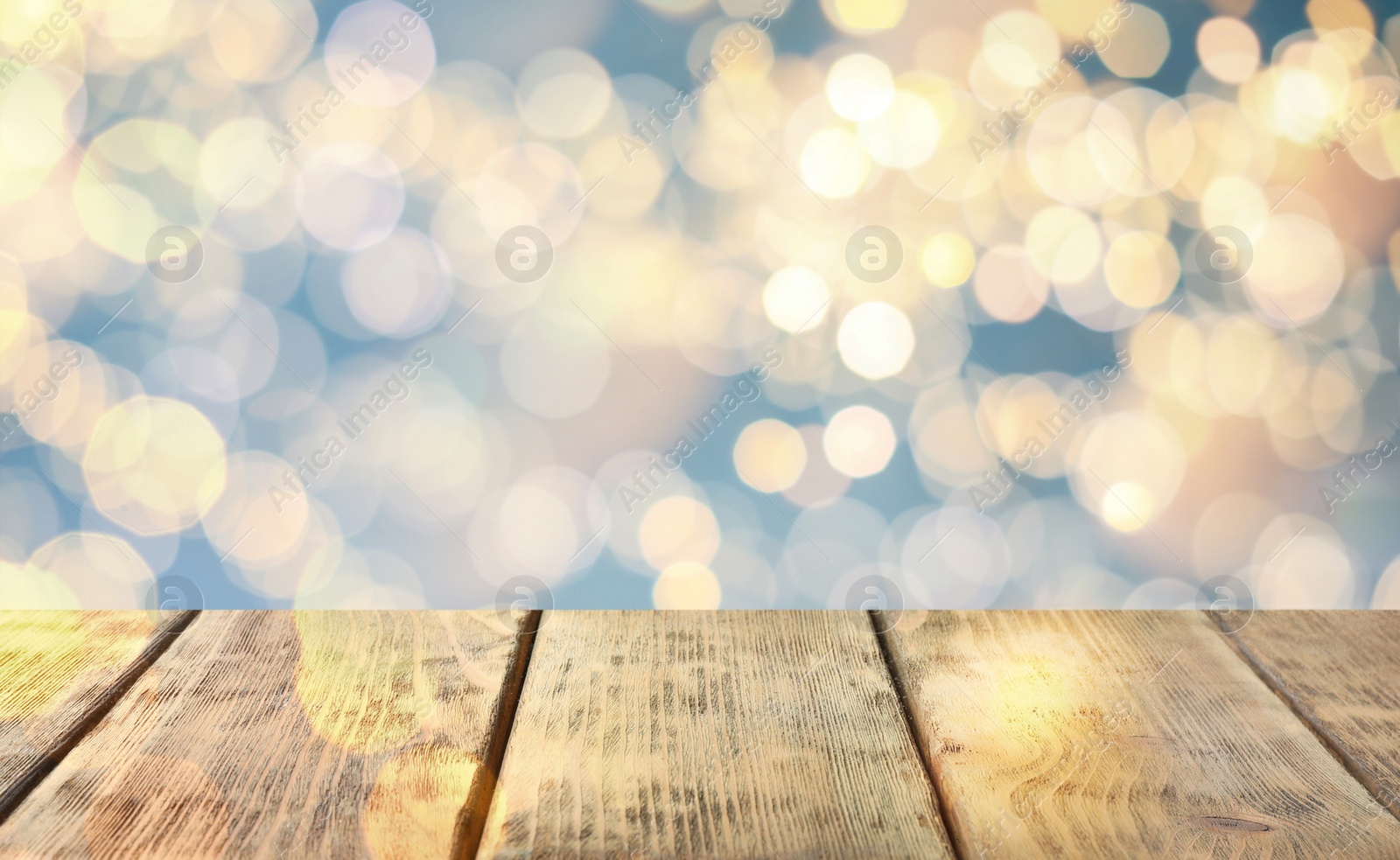 Image of Empty wooden surface and blurred Christmas lights on background, bokeh effect