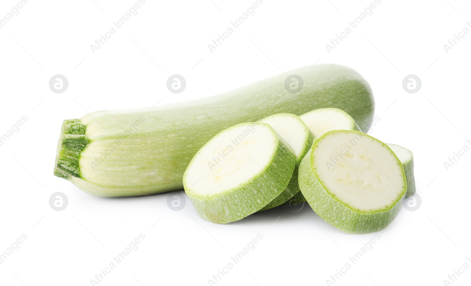 Photo of Cut and whole green ripe zucchinis on white background