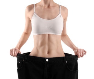 Photo of Young slim woman wearing oversized jeans on white background, closeup