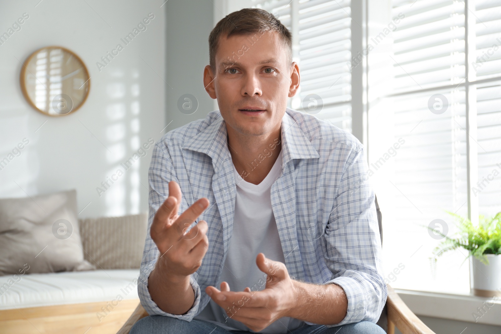 Photo of Man talking to his coworkers through video conference indoors, view from webcam