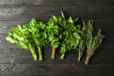 Photo of Different fresh herbs on wooden table, top view