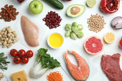 Photo of Flat lay composition with fresh meat and other products for balanced diet on white background