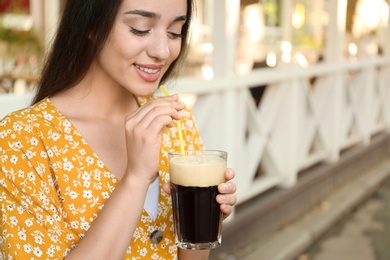 Beautiful woman with cold kvass outdoors. Traditional Russian summer drink