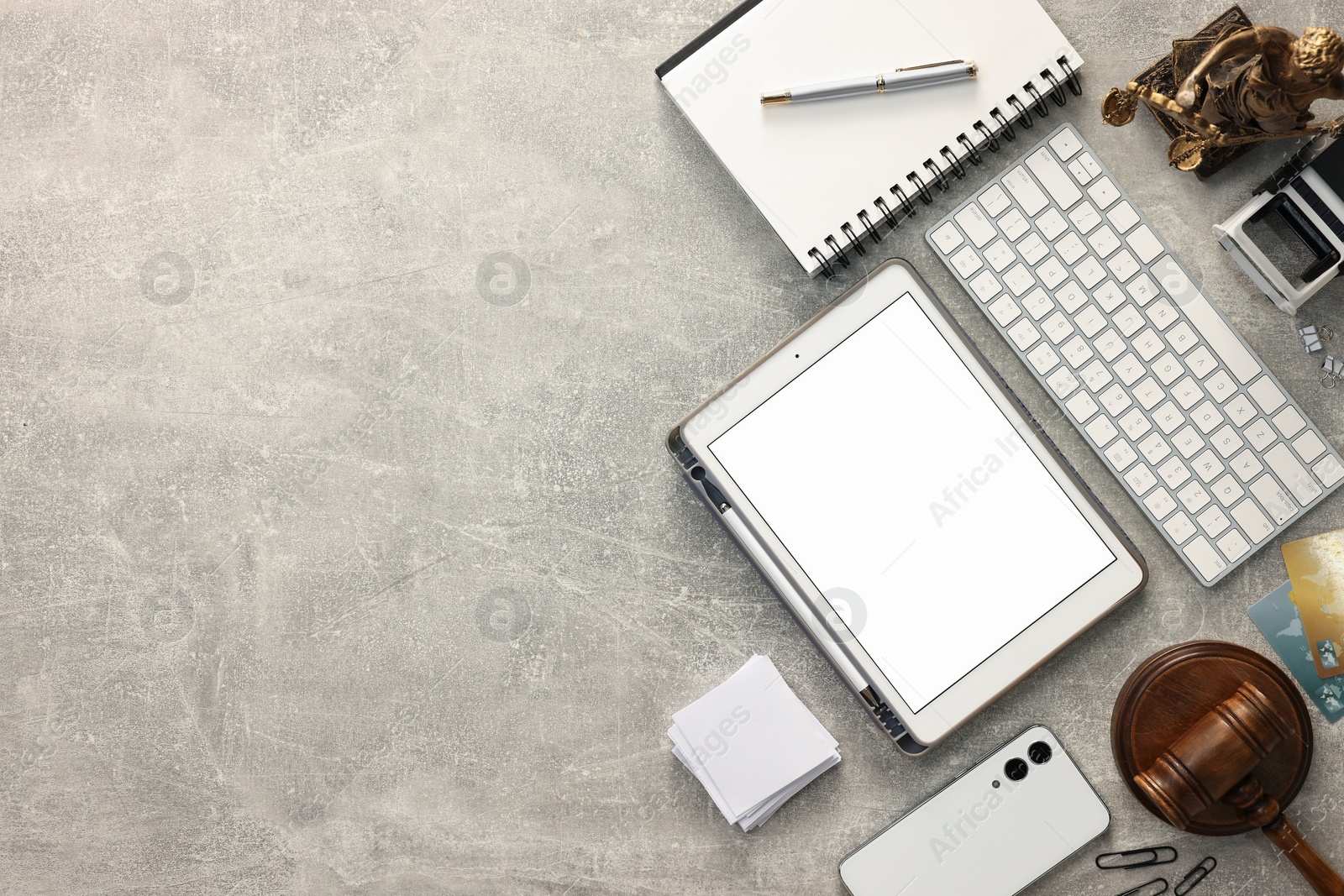 Photo of Flat lay composition with modern tablet on light gray textured table. Space for text